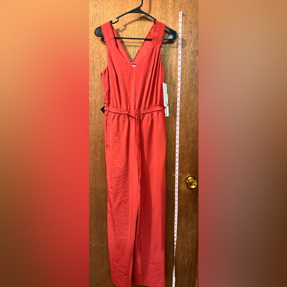 Athleta jumpsuit NWT in fiery coral size 0, loose fitting, all comfy piece.